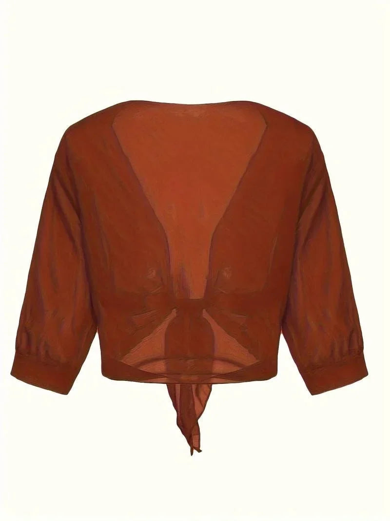 Women's sheer tie-front blouse with 3/4 sleeves, designed for breezy comfort and style.