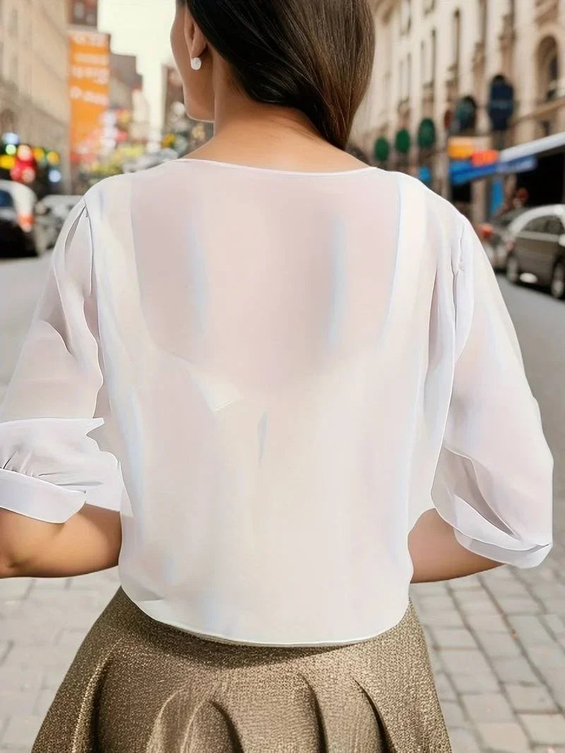 Women's transparent tie-front blouse with three-quarter sleeves, excellent for warm weather.