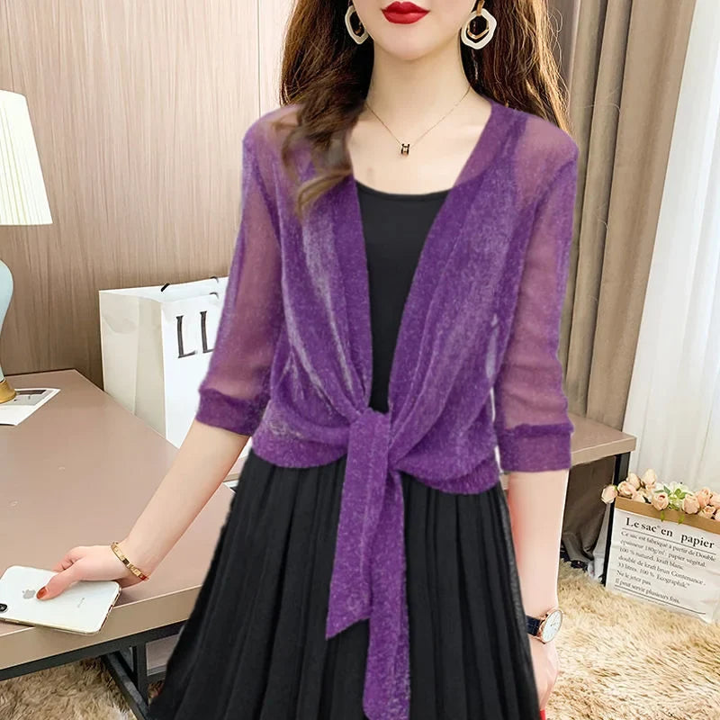 Elegant sheer open-front blouse for women, designed with a chic tie-front and 3/4 length sleeves.
