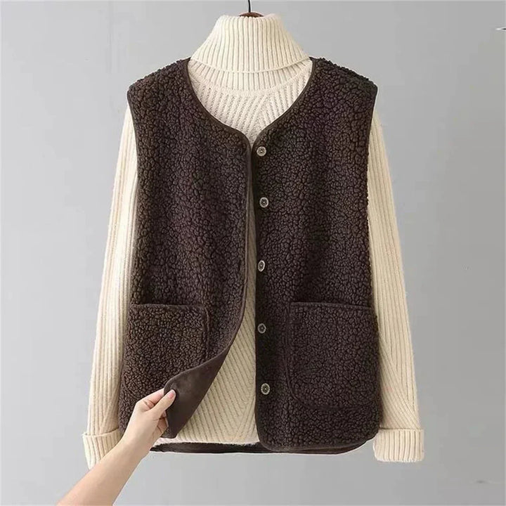 Elegant women's cozy vest, button-front with v-neck & pockets, ideal for winter style.