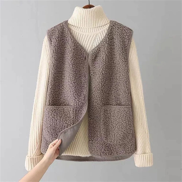 Beige women's cozy button-front vest, v-neck, patch pockets. Stylish autumn layering top.