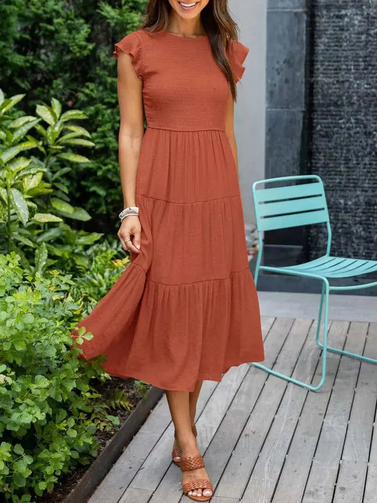 Women's sleeveless smocked midi dress with A-line skirt, airy fabric, perfect for summer occasions. Elegant and comfortable.