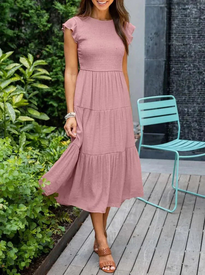 Women's sleeveless smocked midi dress with A-line skirt, airy fabric, perfect for summer occasions. Elegant and comfortable.