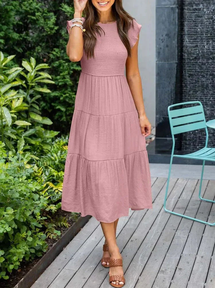 Women's sleeveless smocked midi dress with A-line skirt, airy fabric, perfect for summer occasions. Elegant and comfortable.