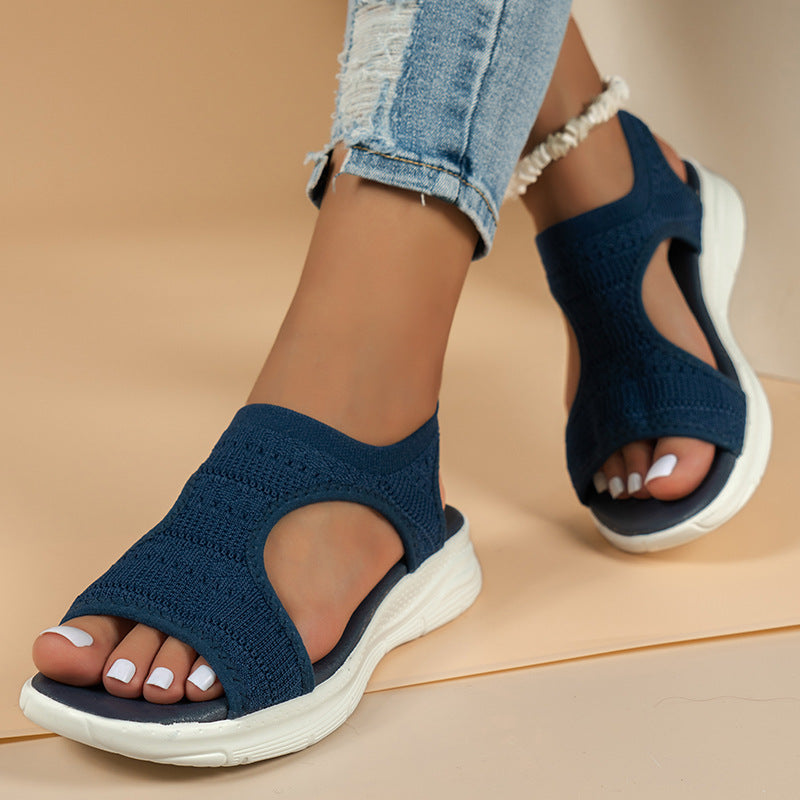 Women's slip-on knit sandals with cushioned sport sole, breathable knit upper, open-toe design; ideal for casual wear.