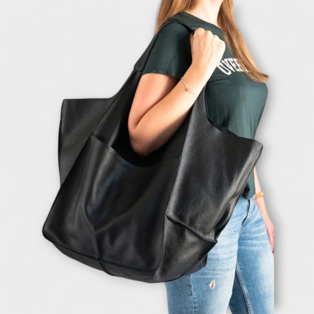 Practical women's faux leather shoulder bag, offering ample space and quick-access exterior pockets.