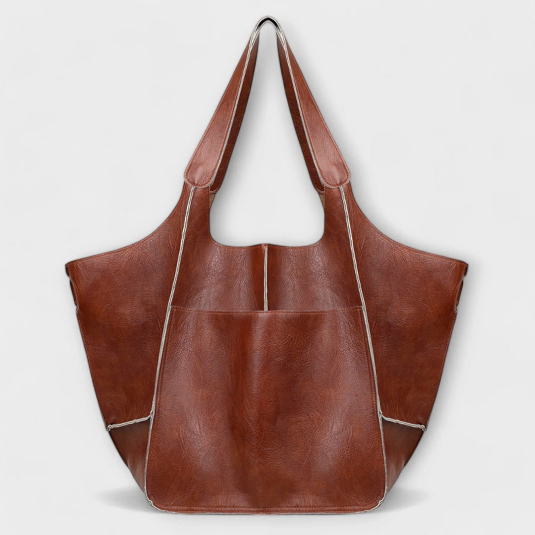 Everyday women's faux leather handbag, a spacious tote with functional exterior storage.