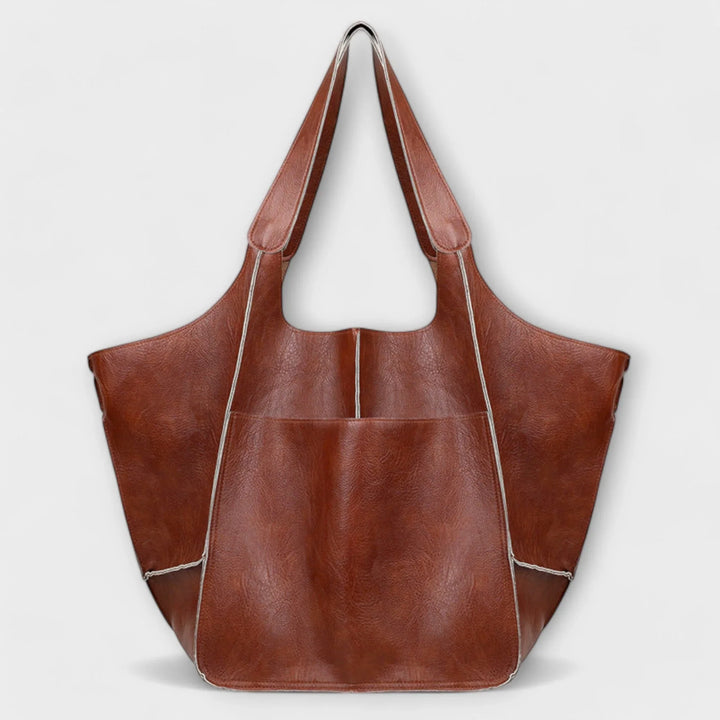Everyday women's faux leather handbag, a spacious tote with functional exterior storage.