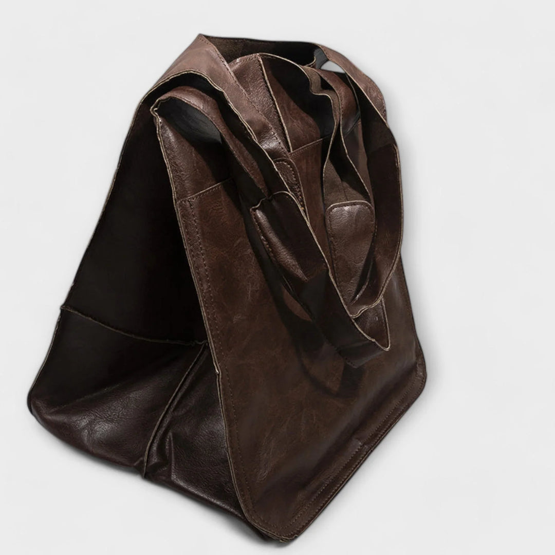 Versatile faux leather tote for women, featuring a spacious design & convenient outer pockets.