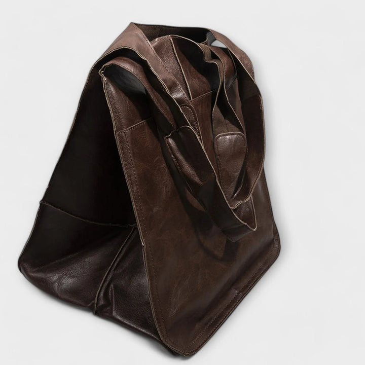 Versatile faux leather tote for women, featuring a spacious design & convenient outer pockets.