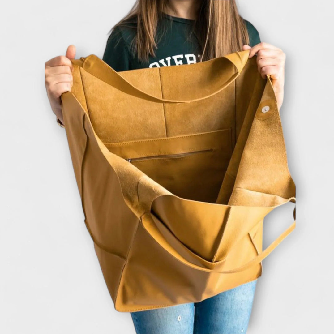 Sophisticated women's spacious faux leather tote, ideal for daily essentials with exterior pockets.