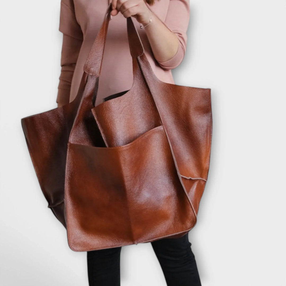 Versatile women's faux leather tote, offering a roomy interior and handy exterior pocket solutions.