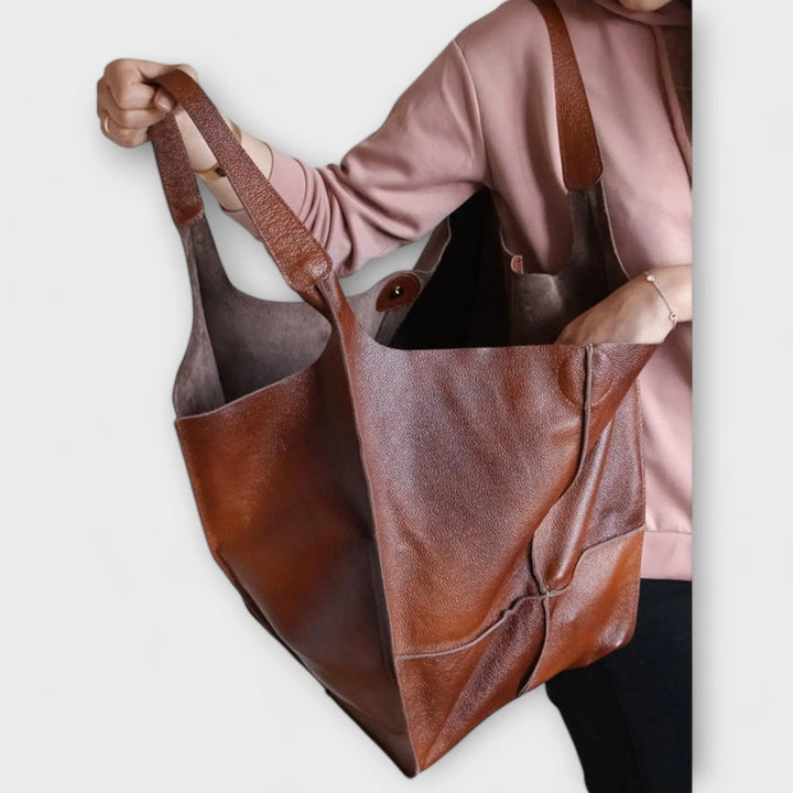 Women's modern faux leather tote; a roomy and versatile handbag with handy exterior pockets.