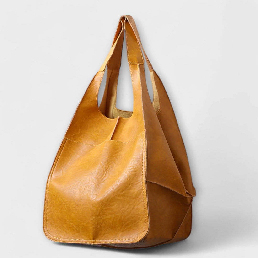 Functional women's shoulder bag: a roomy faux leather tote with multiple exterior compartments.