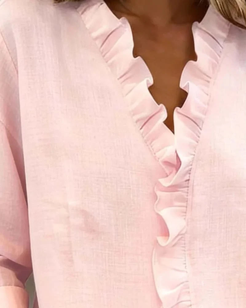 Sophisticated women's elegant top: ruffle V-neck, long-sleeve blouse. Ideal for office wear or casual chic spring looks.