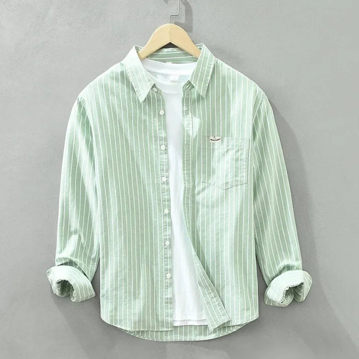 Chic women's blue striped button-up shirt with long sleeves & pocket, ideal for casual or workwear.