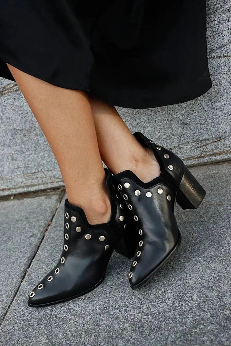Women's black studded ankle boots with pointed toe and comfortable block heel. Edgy fashion statement.