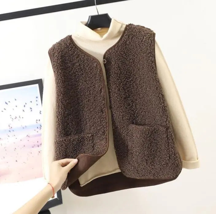 "Women's stylish fleece vest, front view, showing textured design, sleeveless, perfect for winter warmth and elegant style."