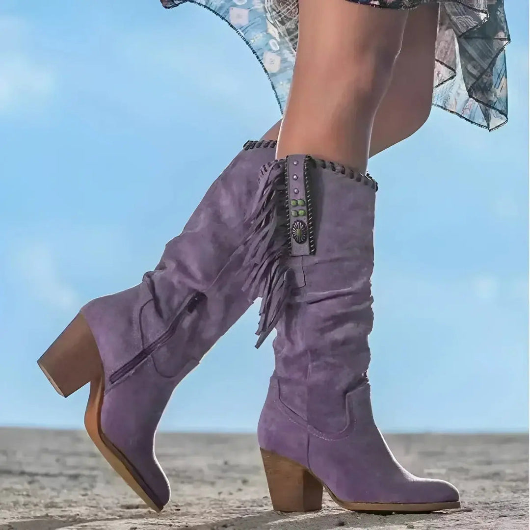 Boho chic women's knee-high western boots featuring stylish fringe, tassels & a comfortable block heel for festivals.
