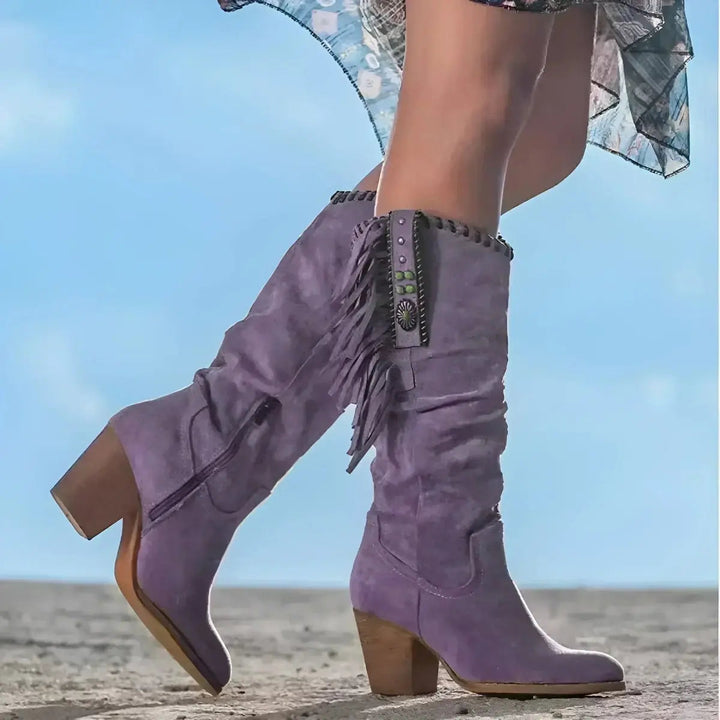 Boho chic women's knee-high western boots featuring stylish fringe, tassels & a comfortable block heel for festivals.