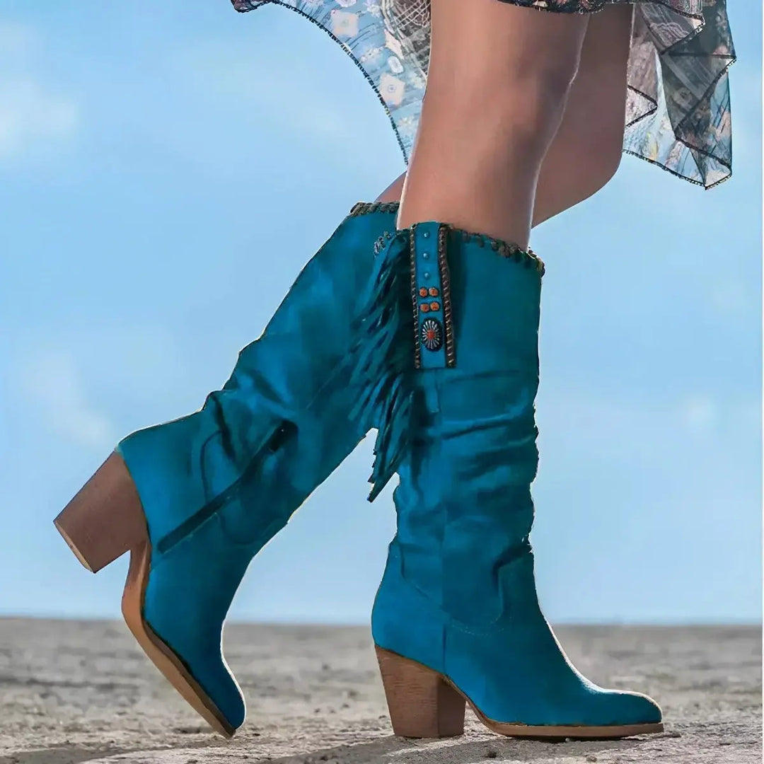 Statement women's fringe tassel knee-high cowboy boots. Tall western footwear with a block heel, ideal for country style.