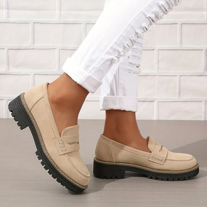 "Women's suede loafers with chunky sole and vamp strap, featuring rounded toe and premium suede for casual elegance."