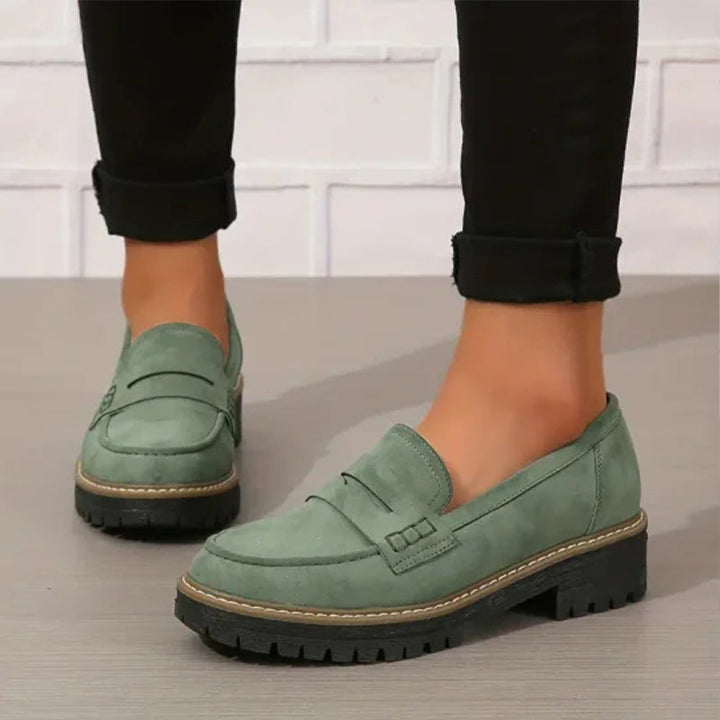 "Women's suede loafers with chunky sole and vamp strap, featuring rounded toe and premium suede for casual elegance."