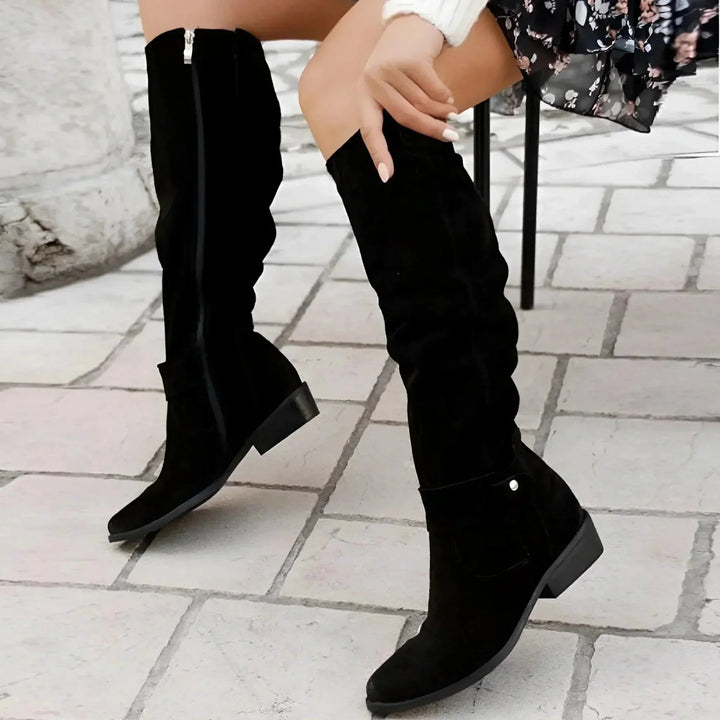 Sophisticated women's slouchy knee-high boots with a sharp pointed toe and discreet side zipper for effortless wear.