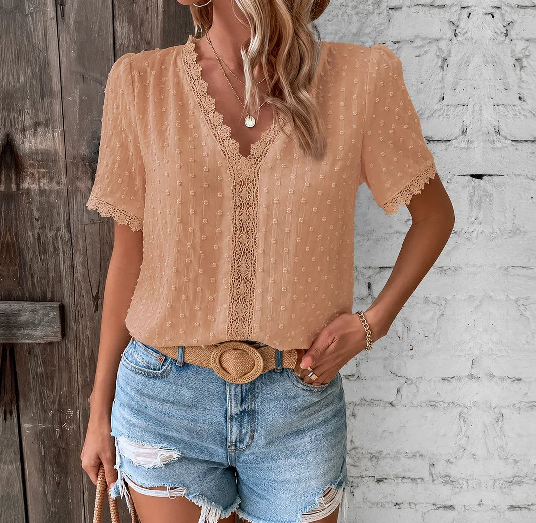 Women's elegant Swiss dot V-neck blouse with delicate lace paneling and short sleeves for a chic summer look.