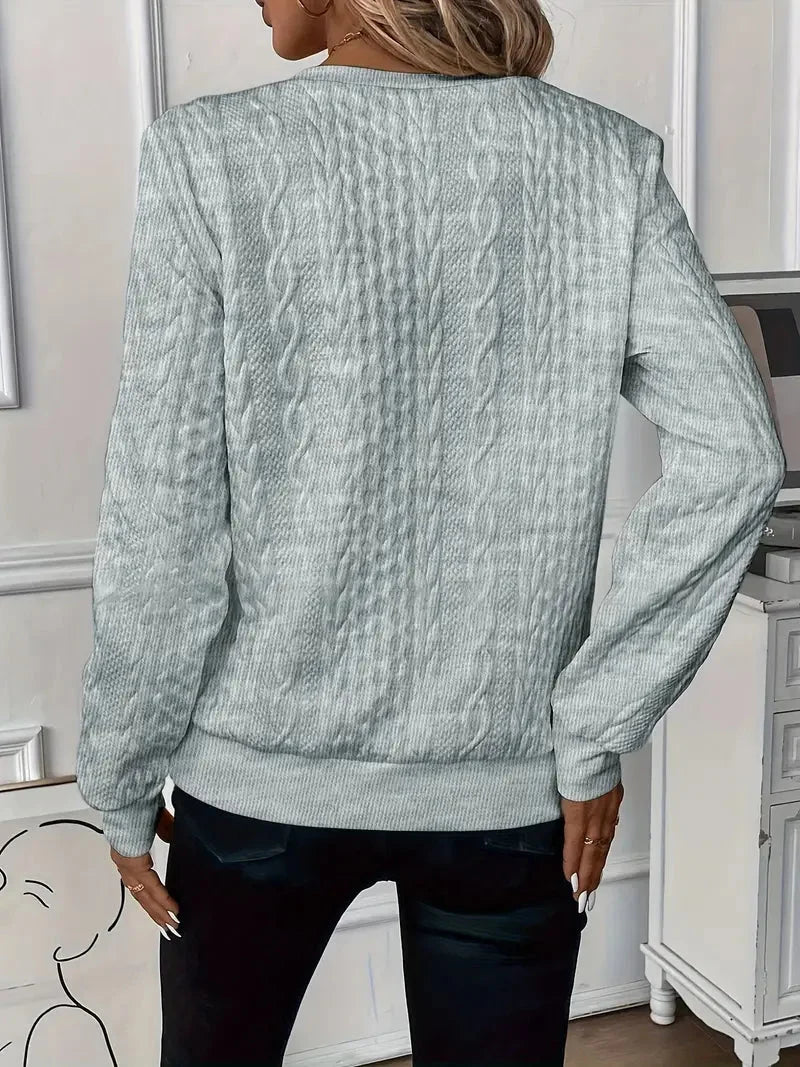 Elegant women's textured knit quarter-zip sweater, long sleeves. Ideal for stylish winter layering.
