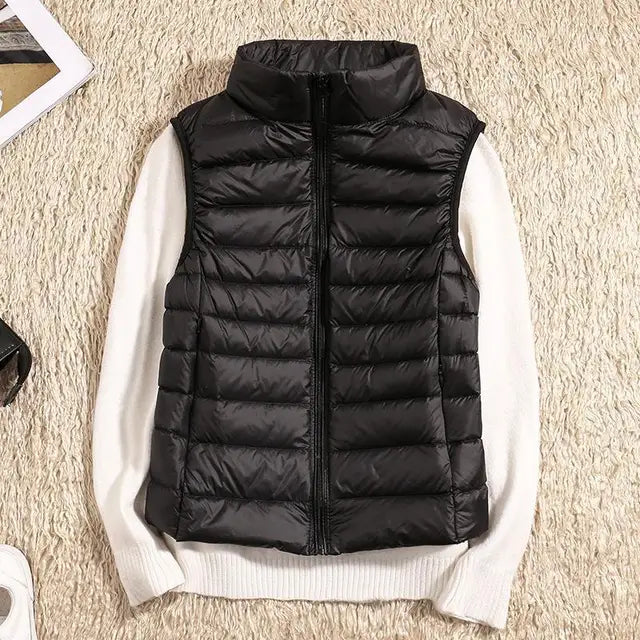 Women's ultra light down vest, warm, lightweight, sleeveless in sleek design, ideal for layering, perfect for chilly days.