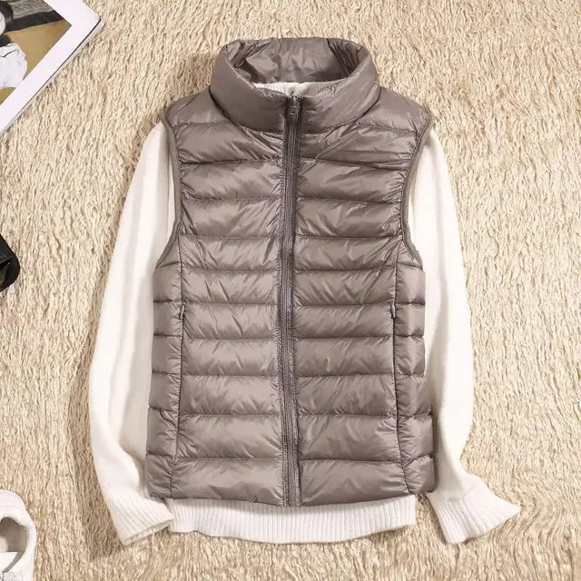 Women's ultra light down vest, warm, lightweight, sleeveless in sleek design, ideal for layering, perfect for chilly days.