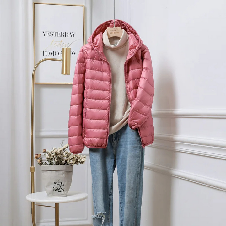 "Women's ultralight foldable puffer jacket with hood, chic design, lightweight, perfect for travel and cold weather."