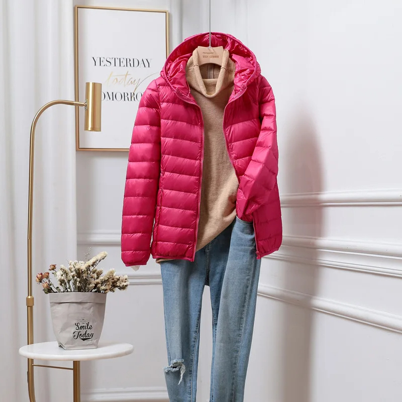 "Women's ultralight foldable puffer jacket with hood, chic design, lightweight, perfect for travel and cold weather."