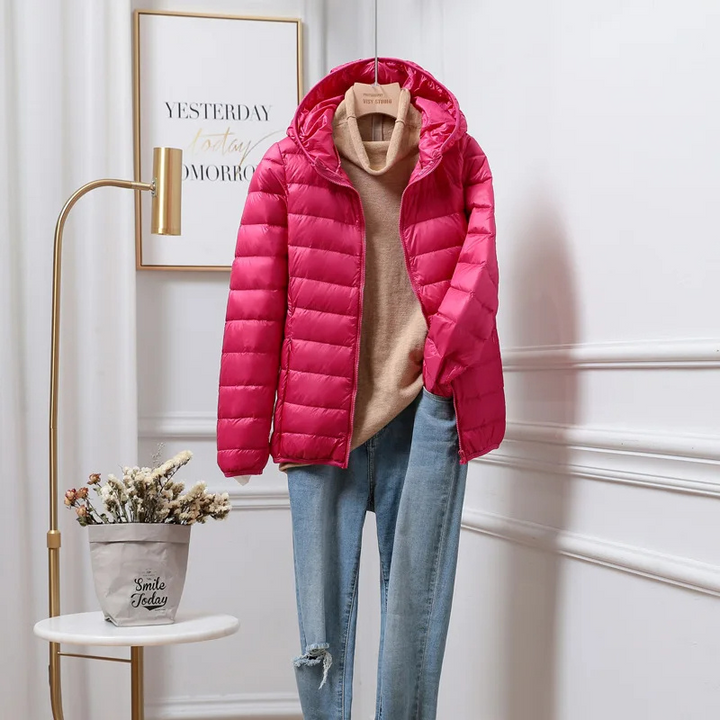 "Women's ultralight foldable puffer jacket with hood, chic design, lightweight, perfect for travel and cold weather."