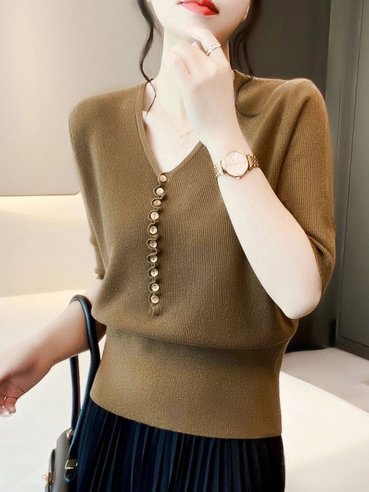 "Women's V-neck button knitted top with relaxed fit, shown in vibrant colors, offering style and comfort for any occasion."