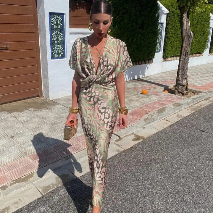 Women's elegant V-neck twist-front midi cocktail dress with a bold animal print. Perfect for parties & evening events.