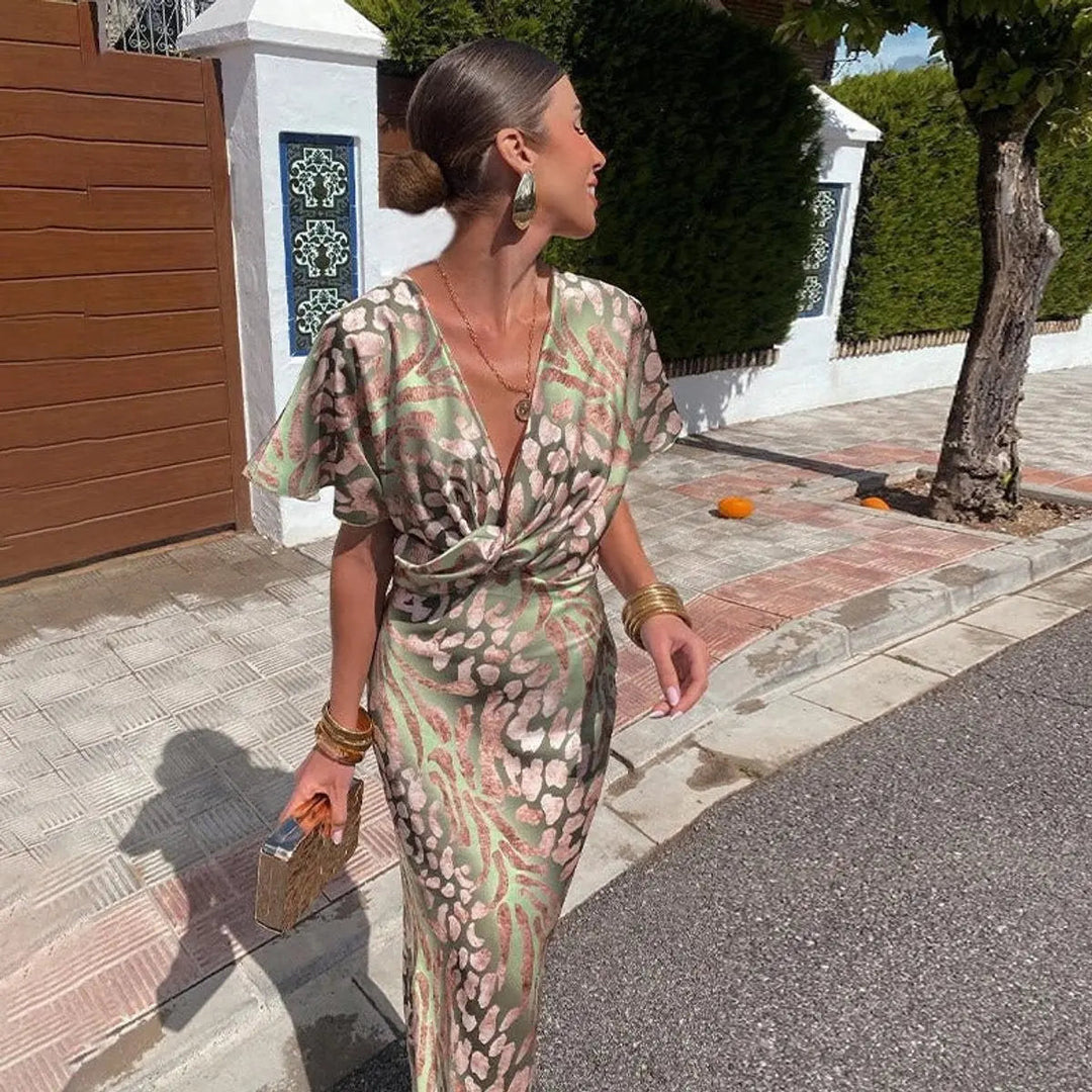 Stylish women's animal print midi dress featuring a flattering V-neck & twist-front. Ideal for autumn/winter occasions.