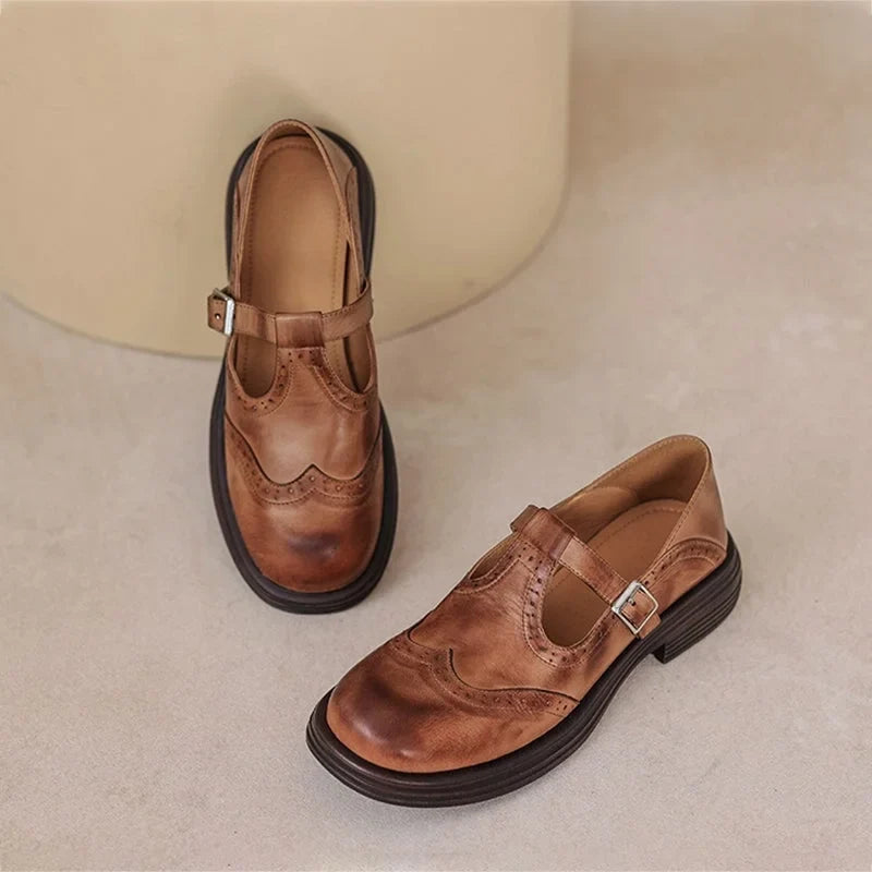 Comfortable classic Mary Jane sandals for women, featuring intricate brogue detailing & secure buckle.