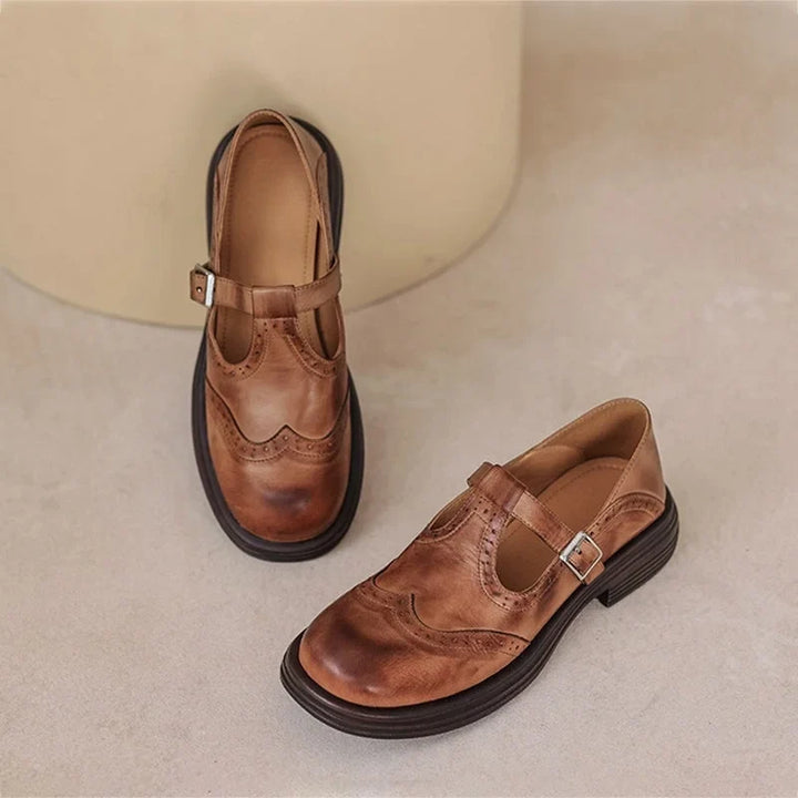 Comfortable classic Mary Jane sandals for women, featuring intricate brogue detailing & secure buckle.