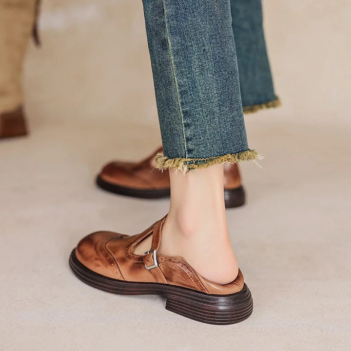 Flat Mary Jane sandals with brogue detailing & buckle strap, ideal for comfortable women's summer wear.