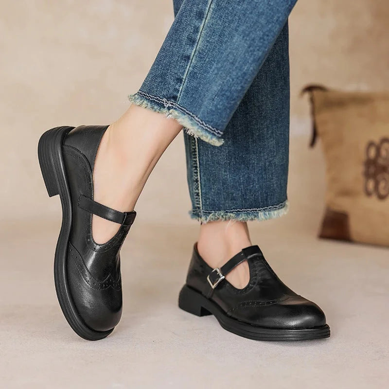 Classic women's Mary Jane buckle strap sandals, featuring elegant brogue perforations for a refined look.