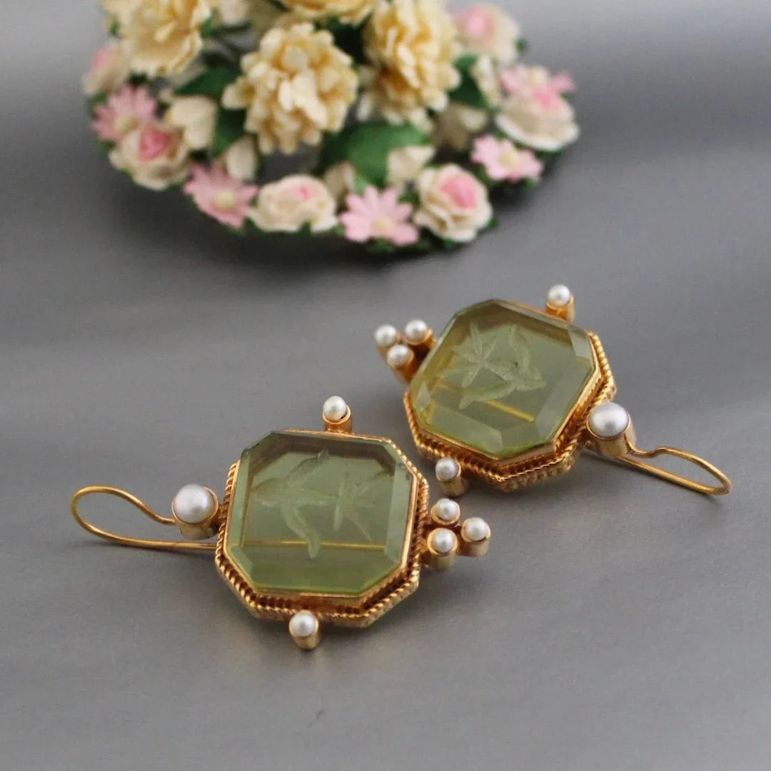 Elegant women's vintage gold-tone earrings featuring an octagonal design & carved green stone. Dangle statement jewelry.
