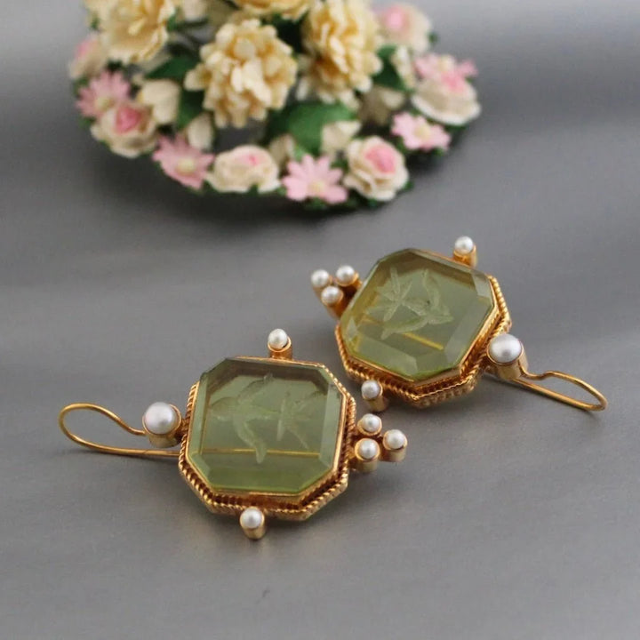 Elegant women's vintage gold-tone earrings featuring an octagonal design & carved green stone. Dangle statement jewelry.