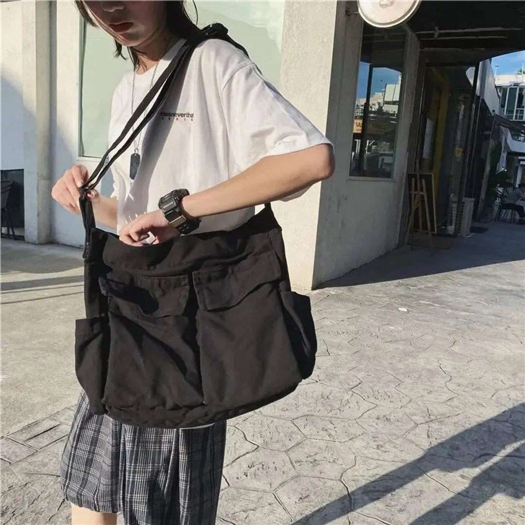 Stylish women's vintage canvas shoulder bag with multiple pockets, ideal for a retro look.