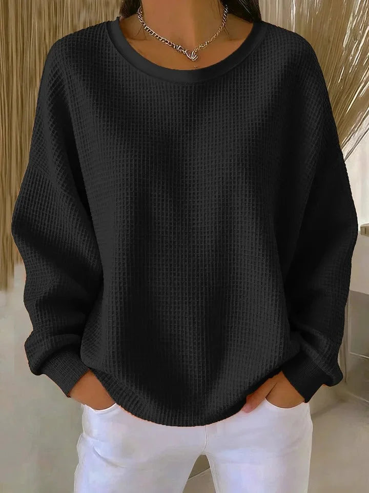 Textured waffle knit women's sweater, cozy & relaxed fit, long sleeves for warmth.