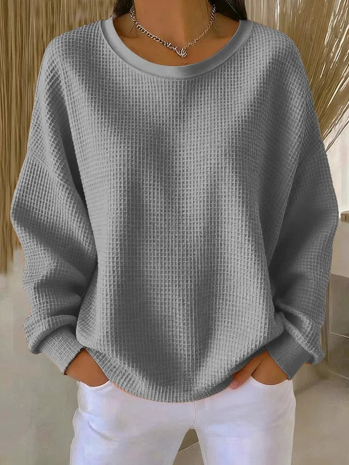 Women's fall/winter cozy waffle knit sweater with relaxed fit & long sleeves.