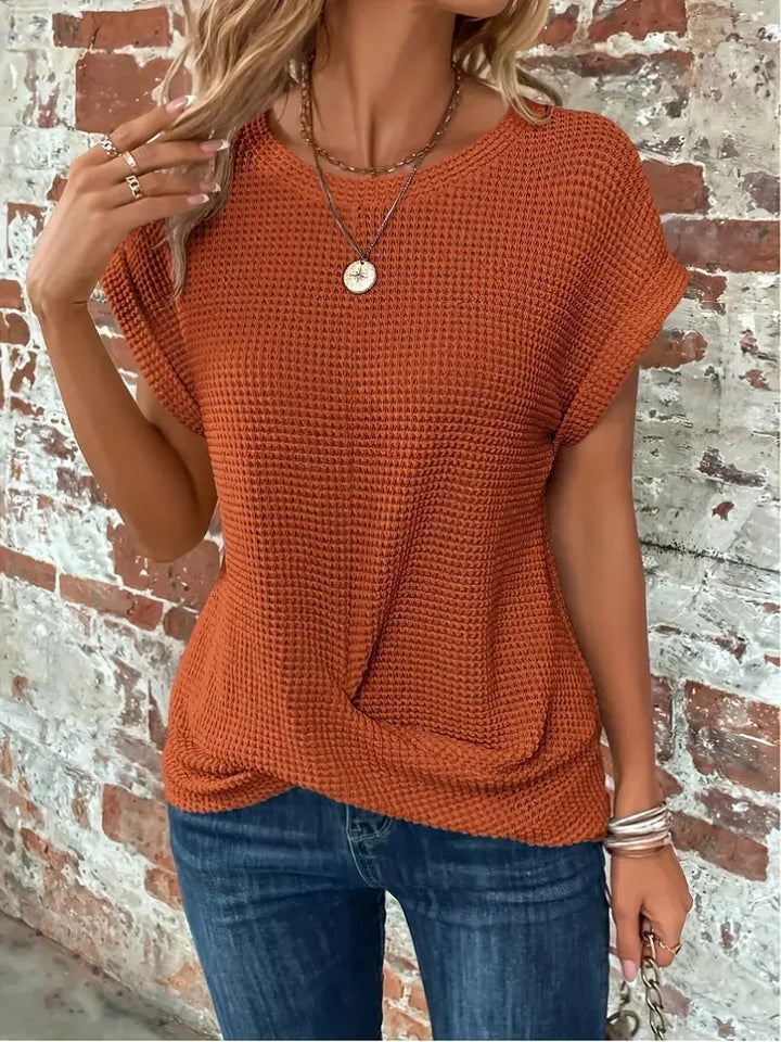 Women's short sleeve waffle knit top. Front twist detail adds style to this comfortable casual sweater.