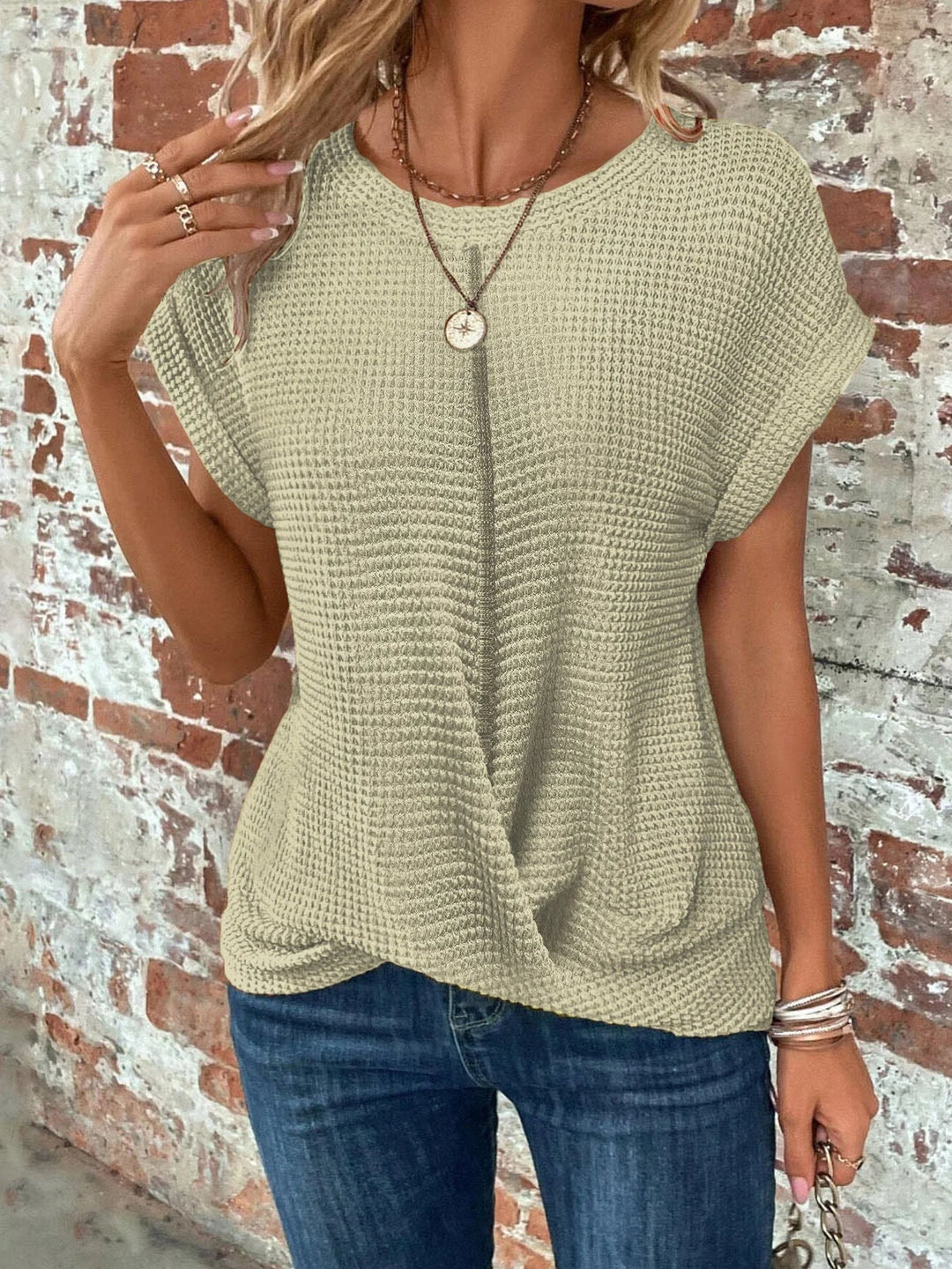 Women's crew neck short sleeve waffle knit top featuring a unique front twist detail. Everyday casual wear.