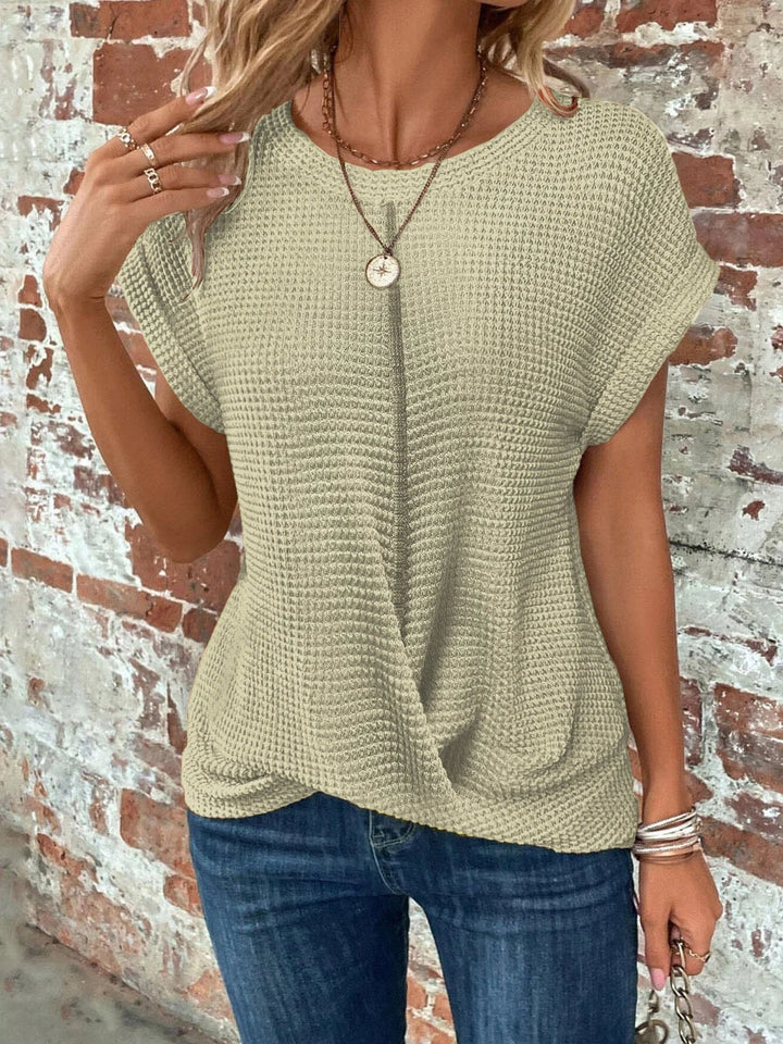 Women's crew neck short sleeve waffle knit top featuring a unique front twist detail. Everyday casual wear.